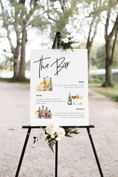 a sign that says the bar on it with flowers and bottles in front of it