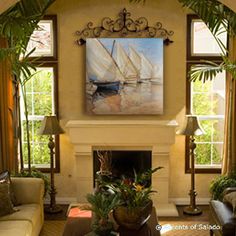 a living room filled with furniture and a painting on the wall