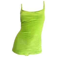 Chic early 2000s does 1960s OSCAR DE LA RENTA neon lime green one piece Size 14 swimsuit or bodysuit! Features a flattering boy cut front that hides any problem areas. Straps can be switched to a racerback for added support. A great pop of color that is great for the beach, pool, or yacht. Would also be great as a bodysuit with shorts, jeans or a maxi wrap skirt. In great condition. Made in USA Marked Size US 14 (runs true to size, but could also fit a size 16) Measurements: (plenty of stretch) Bodysuit With Shorts, Fringe Swimsuit, Maxi Wrap Skirt, Laura Bush, Green Bathing Suits, Green Costumes, Green One Piece Swimsuit, Boy Cut, Green One Piece