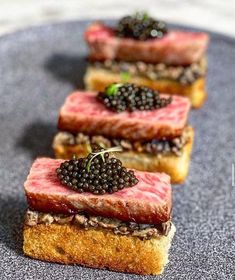 three pieces of bread with blackberries on top