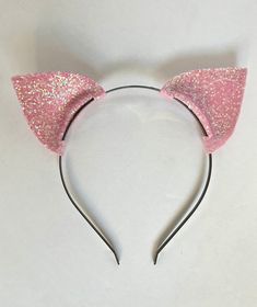 "These sparkly light pink cat ears are a fun headband to wear, for a party or even a holiday. I have used a soft light pink foam to create the ears and applied chunky iridescent glitter all over.  The ears measure about 2.5\" in width + in height. The ears are attached to a slim metal headband, which is a standard size.  Please contact me for any questions! :)" Novelty Party Hair Accessories With Animal Ears, Novelty Cat Ears Hair Accessories For Parties, Novelty Party Hair Accessories With Cat Ears, Party Novelty Cat Ears Hair Accessories, Party Headband With Ears, Novelty Party Hair Accessories With Ears, Party Hair Accessories: Bunny Ears Headband, Pink Headband With Ears For Gift, Pink Ears Headband Gift