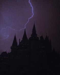 a lightning bolt is seen in the sky over a castle