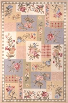 a patchwork rug with flowers and leaves on the front, in pastel colors