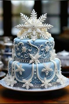 a blue and white cake with snowflakes on top