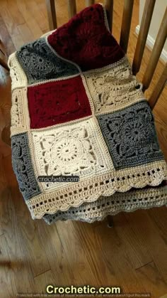 a crocheted blanket sitting on top of a wooden chair