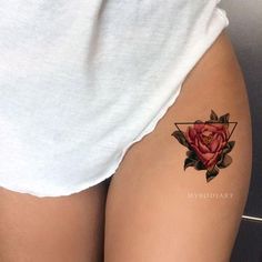 a woman with a rose tattoo on her thigh