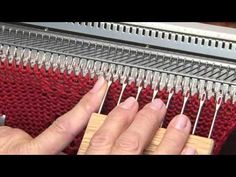 someone is working on some kind of weaving machine with their fingers and thumbnails