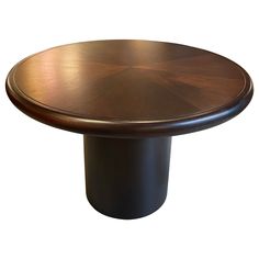 a round wooden table with black base on a white background for use as a centerpiece