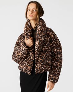 Designed for both style and functionality, the EVY jacket is a must-have for any fashion-forward individual. The textured shawl collar adds a luxurious touch, while the functional pockets provide convenience. With a magnetic closure at the front, this puffer jacket provides extra warmth for any occasion. Leopard puffer jacket Shawl collar Magnetic closure Length: 23.5" 100% polyurethane Hand wash Luiza is 5ft 9.5in and is wearing a size small Stephanie is 5ft 10in and is wearing a size large Imp Chic Quilted Outerwear For Fall, Chic Puffer Outerwear For Fall, Chic Fall Puffer Outerwear, Trendy Puffer Jacket With Padded Collar For Workwear, Chic Puffer Jacket For Workwear In Fall, Chic Winter Puffer Jacket For Work, Chic Fall Puffer Jacket For Workwear, Leopard Coat, Bodysuit Jumpsuit