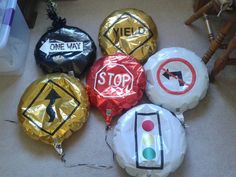 several different types of balloons with stickers on them sitting on the floor next to each other