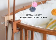 a baby crib with two stuffed animals hanging from it's sides and the words you can mount horizontal or vertically