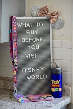 a sign that says, what to buy before you visit disney world is on the counter