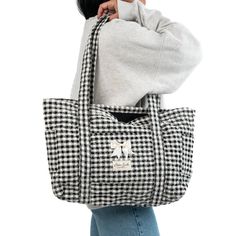 Our Classic Tote Bag is a cozy and stylish bag that combines every-day convenience with a classic design. It features 3 exterior pockets, and a bow for an added touch of elegance.   The quilted exterior boasts a beautiful black & white gingham pattern, complemented by the matching minimal black interior.   Ideal for carrying books and groceries, or hauling beach gear and gym clothes, this bag is a must have for anyone who values versatility.   Size: 16.5" x 12" x 5" (42cm x 30cm x 12cm) Vintage Everyday Tote Bag, Edgy Travel Tote Bag, Brown Quilted Tote Bag, Retro Beige Tote Bag, Traditional Black Tote Bag, Mini Makeup Bag, Classic Tote Bag, Large Makeup Bag, Vanity Bag