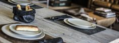 the table is set with plates, silverware and napkins for two people to eat