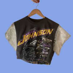 a woman's black and white shirt hanging on a hanger with the name johnon printed on it