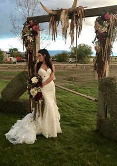 the bride and groom are standing under an altar