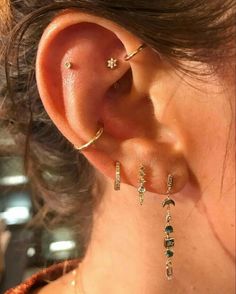 a close up of a person wearing ear piercings