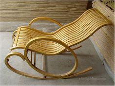 a wooden rocking chair sitting on top of a cement floor next to a window sill