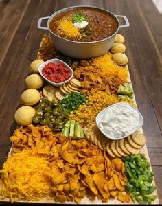 a large platter filled with chips and dips