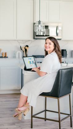 a woman sitting in a chair with a laptop