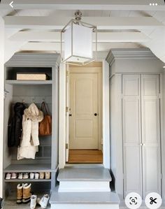 an open closet with shoes and handbags on the steps leading up to the door