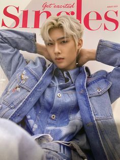 a person sitting on top of a magazine cover wearing a denim jacket and jeans pants