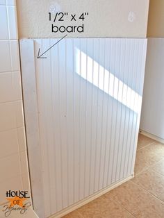 a bathroom with white walls and tile flooring next to a wall mounted heater