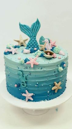 a blue cake decorated with sea creatures and stars