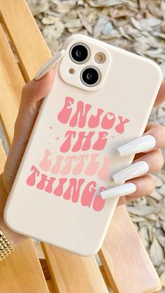 someone holding up their phone case with the words enjoy the little things on it