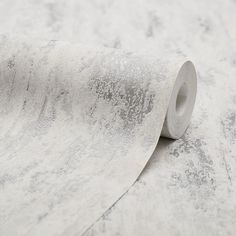 a roll of white paper on top of a marble flooring material that looks like it has snow flakes all over it