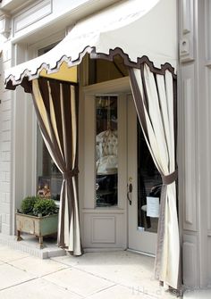 an image of a storefront with curtains on it