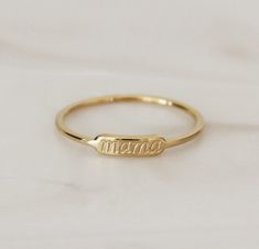 "A dainty, every day ring perfect for mamas and mamas to be. A sentimental piece that will be cherished by all beautiful mamas. Makes the perfect push present, Mother's Day gift, or gift for oneself * Featuring a tiny bar with \"mama\" in our signature script. Photo is a close up image for details. Please refer to our measurements for scale/sizing. Shown paired with our Grace Band. Please note this listing is for the mama ring only. ⚫ Base Material: High Quality Surgical Steel Finish: 18K Gold, Minimalist Initial Ring For Mother's Day, Dainty Adjustable Engraved Ring For Everyday, Dainty Everyday Adjustable Engraved Ring, Adjustable Name Rings For Everyday Wear, Everyday Adjustable Rings With Name Detail, Mother's Day 14k Gold Stackable Rings, Adjustable Everyday Rings With Personalized Name, Dainty Personalized Midi Rings For Everyday, Minimalist Stackable Rings For Wedding And Mother's Day