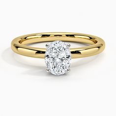 a yellow gold ring with a oval cut diamond