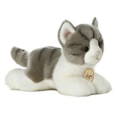 a gray and white stuffed cat laying down