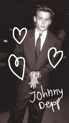 a man in a suit with hearts drawn on it