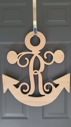 an anchor is hanging on the front door with a hook in it's center