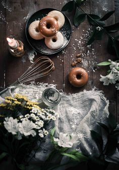 doughnuts and flowers on a wooden table