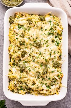 broccoli and cheese casserole in a white dish on a gray surface