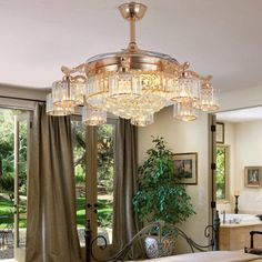 a chandelier hanging from the ceiling in a living room with sliding glass doors