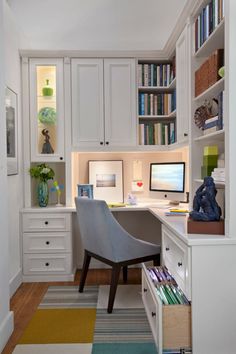 an image of a home office with white cabinets and desks on the left side