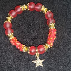 This Red & Gold Beaded Fashion Bracelet With Star Charm Is A Beautiful Dainty Piece, Perfect For Summertime. Too Cute To Pass Up. Don't Wait. Get It Now! Red Beaded Charm Bracelet For Jewelry Making, Red Beaded Bracelets With Spacer Beads For Party, Adjustable Red Charm Bracelet For Party, Red Beaded Bracelets With Colorful Beads For Christmas, Red Beaded Bracelet With Colorful Beads For Christmas, Red Star-shaped Beaded Jewelry, Red Beaded Crystal Bracelet For Party, Red Beaded Stretch Bracelet For Christmas, Star-shaped Beaded Jewelry For Party