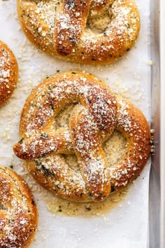 freshly baked bagels covered in powdered sugar and sprinkled with parmesan cheese