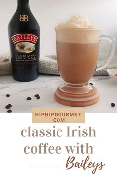 a bottle of bailey's irish coffee next to a glass with whipped cream in it