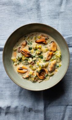 a bowl filled with food on top of a blue cloth