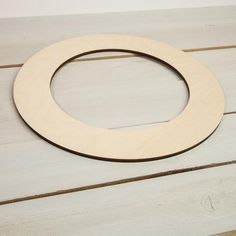 a wooden circle sitting on top of a white table