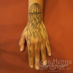 a woman's hand with a tattoo on it and a jellyfish in the middle