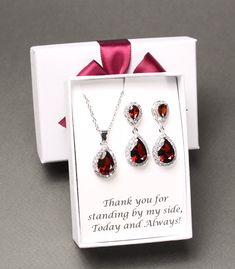 "Burgundy bridesmaid earrings Dark red tear drop earrings Bridesmaid gift bridesmaid necklace bracelet bridesmaid jewelry This set features AAA top burgundy CZ crystal posts matched with bottom tear drop burgundy pendants, and matching necklace and bracelet set. They are in Rose gold, Gold and White gold (silver colored) plated settings, nickel and lead safe, and are tarnish resistant. Earrings measure 1.25 (31mm) inches in lengths.  Clip on earrings for non pierced ears are also available, please leave a note at checkout. Necklace measures 16 inches with extensions adjustable to 18.5 inches. Other lengths are also available at your request.  Burgundy bracelet measures 6.5 -7.5 inches with removeable extender links.  Please leave a note in the \"add a note to seller\" box at checkout for c Sterling Silver Jewelry Sets For Wedding On Valentine's Day, Valentine's Day Teardrop Jewelry Set With Matching Earrings, Elegant Teardrop Jewelry For Valentine's Day, Valentine's Day Wedding Jewelry With Matching Earrings, Mother's Day Formal Jewelry With Matching Earrings, Red Drop Jewelry For Gift, Formal Red Dangle Jewelry Sets, Red Drop-shaped Jewelry For Gift, Dangle Teardrop Earrings In Cubic Zirconia As Gift