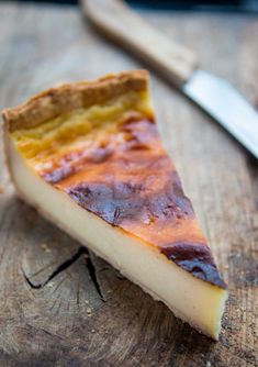 a piece of cheesecake sitting on top of a wooden table