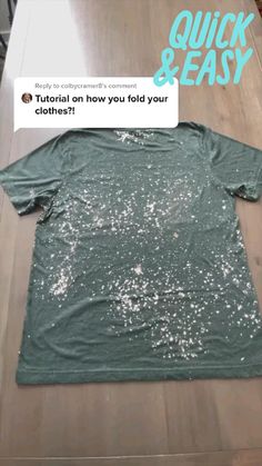 a t - shirt with glitter on it sitting on top of a table