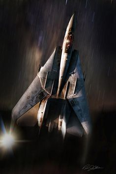 a fighter jet flying through the air with rain coming down on it's wings